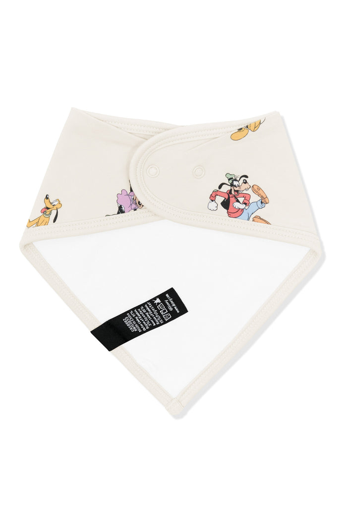 Back side fabric of bib with mickey mouse and friends print on an oat background