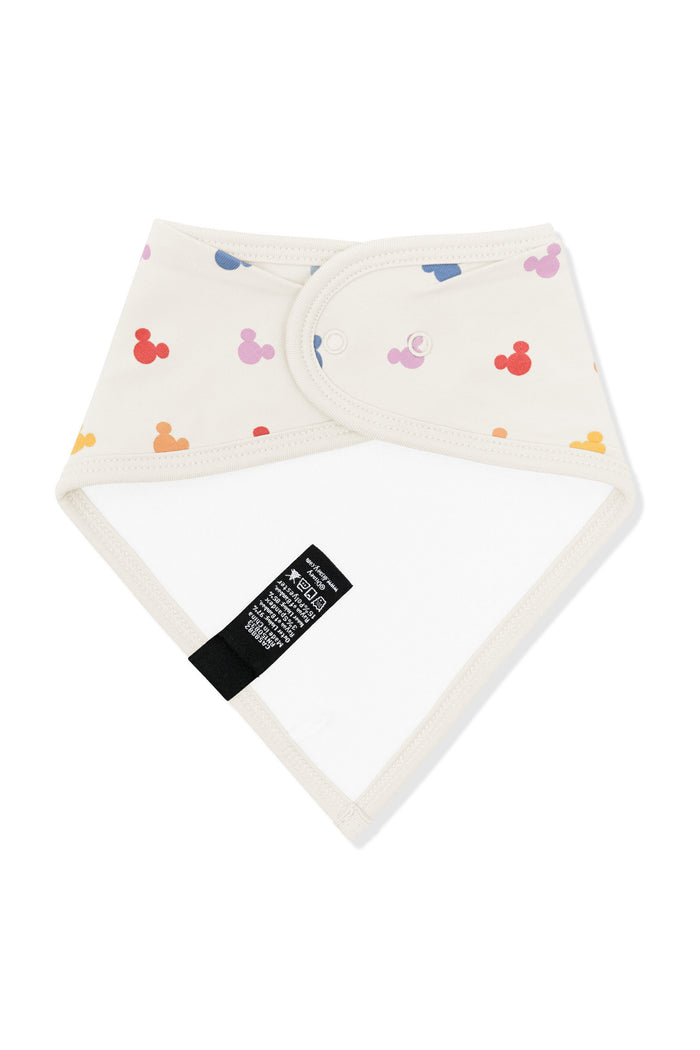 Back side fabric of bib in pastel mickey mouse icons on an oat background