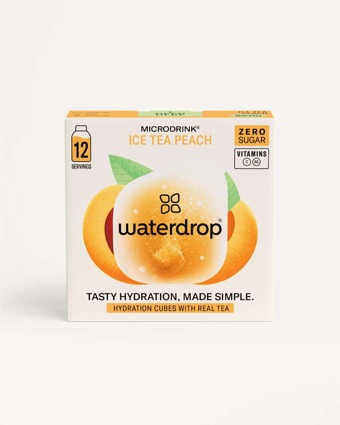 Box of waterdropยฎ ICE TEA Peach beverage, offering sweet, fruity flavor with black tea tartness, no sugar, transforming water into refreshing iced tea.