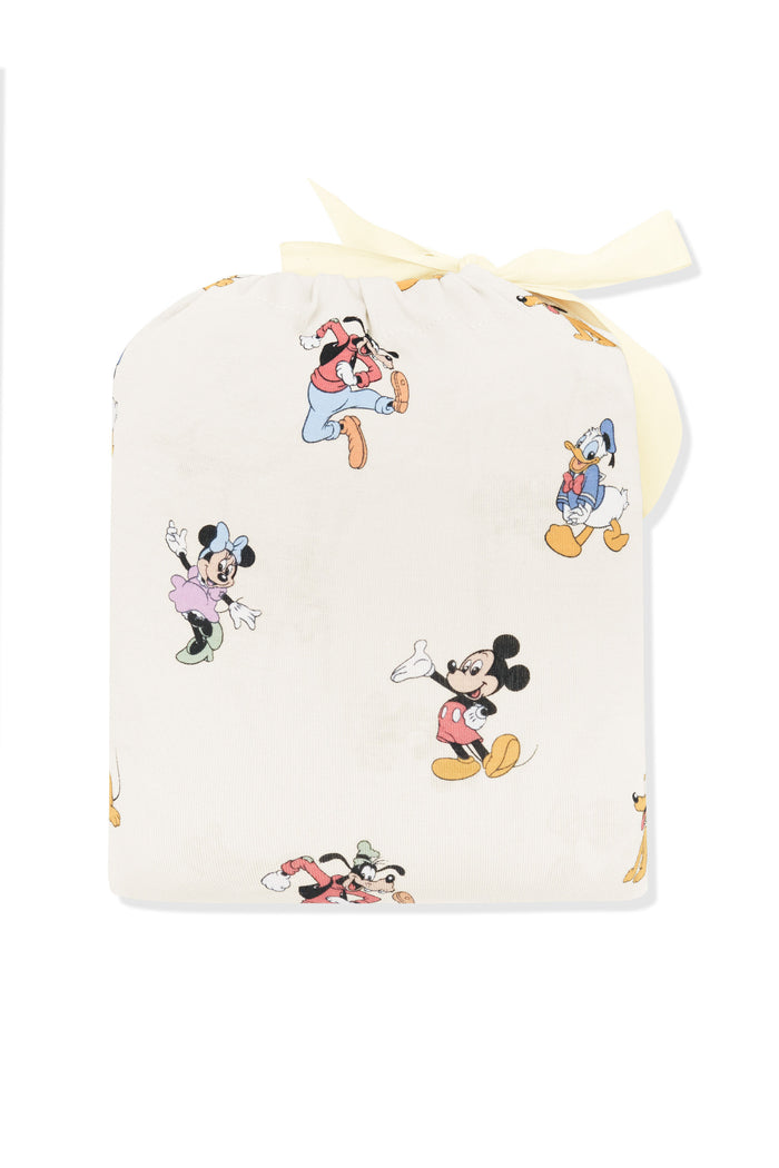 Crib sheet in mickey mouse and friends print shown in its packaging