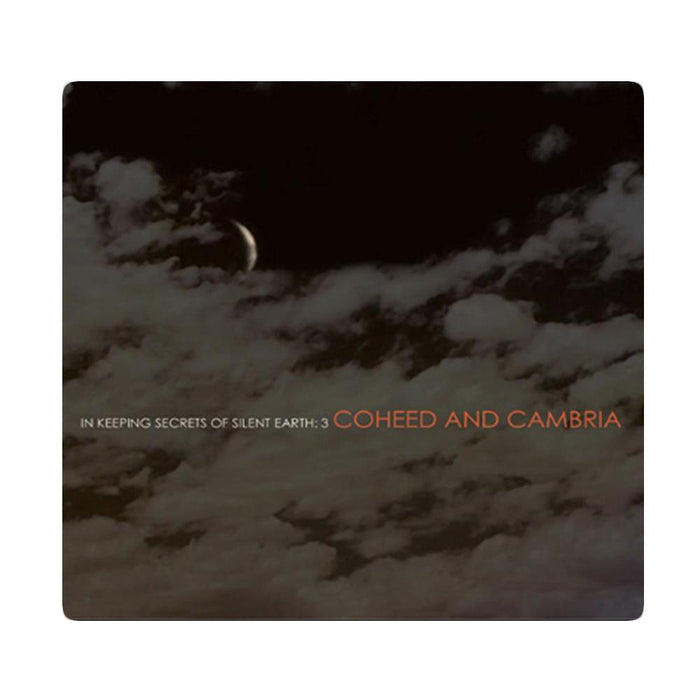 Cd cover that shows a dark night sky with clouds across the image. There is text that reads In Keeping Secrets of Silent Earth: 3 and Coheed and Cambria as well. There is a white border around all of this.