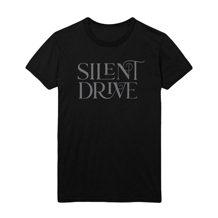 Image is a black Tee shirt with Grey Lettering that reads “Silent Drive” across the chest