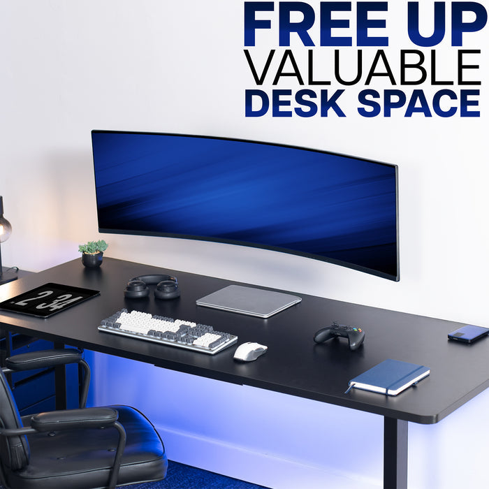 Modern office desk setup with a large monitor, keyboard, mouse, and chair, featuring text 'FREE UP VALUABLE DESK SPACE'.