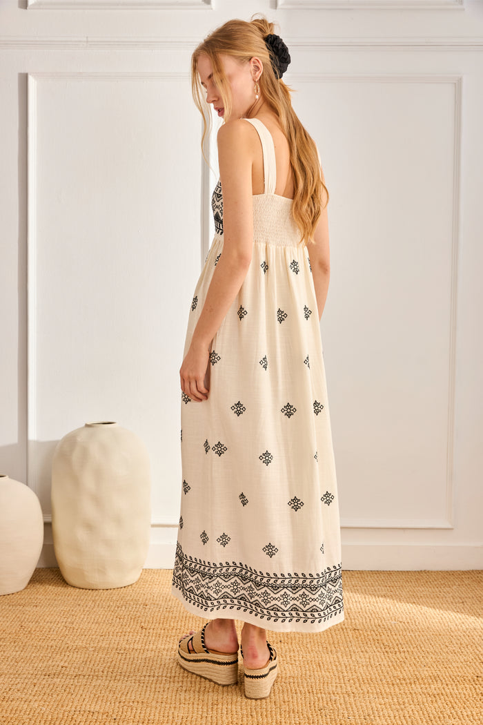 Side view of model in NKN Nekane Urani Ivory Long Linen Dress with Embroidery and Square Neckline, shop nkn nekane at Dotique