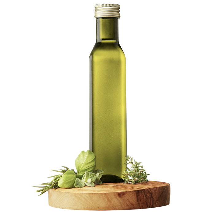 A bottle of Extra Virgin Olive Oil with a green tint, accompanied by herbs typically found in Provençal cuisine, displayed on a wooden platform.