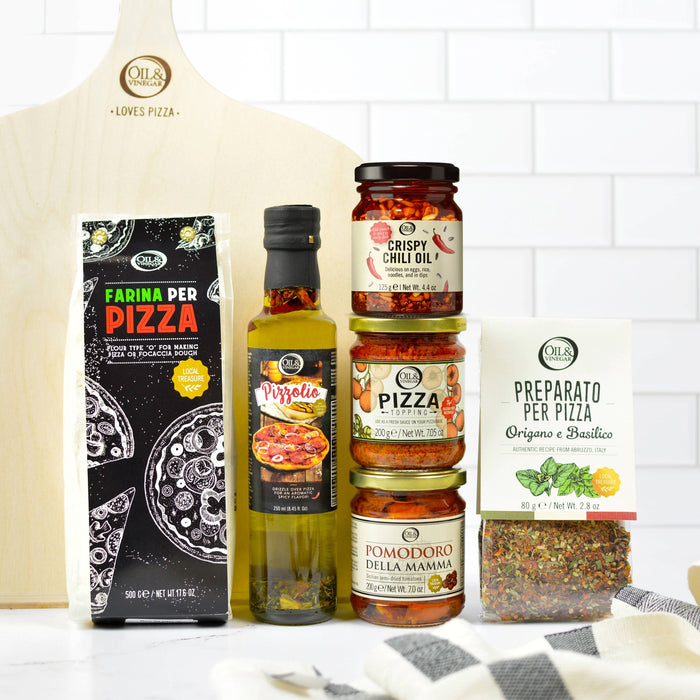 Collection of pizza-making ingredients and products on a kitchen counter.