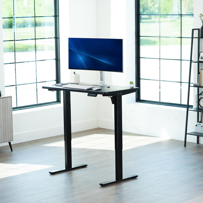 Black, Single Motor Electric Desk with Push Button Memory Controller, in a bright office setting.