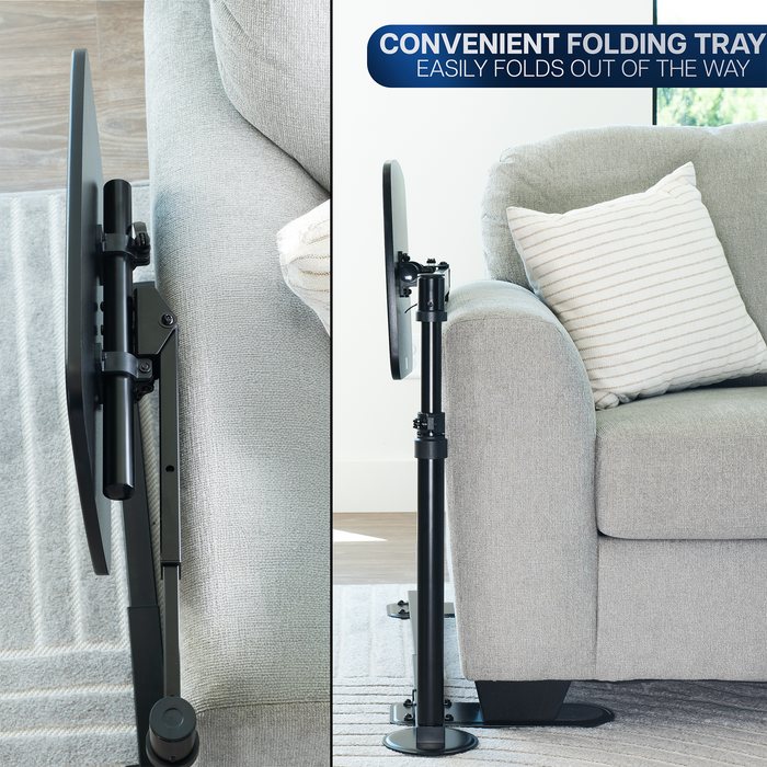 Black adjustable laptop desk with a convenient folding tray feature, shown in a living room setting.