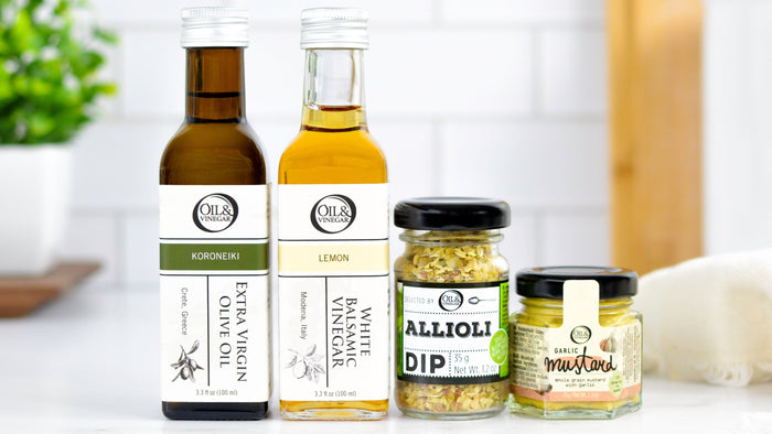 two bottles and two jars of different products on a white surface with a blurred background