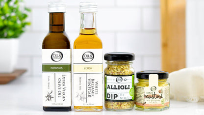 two bottles and two jars of different products on a white surface with a blurred background