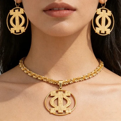 Woman wearing gold statement earrings and twisted rope necklace with African pendant