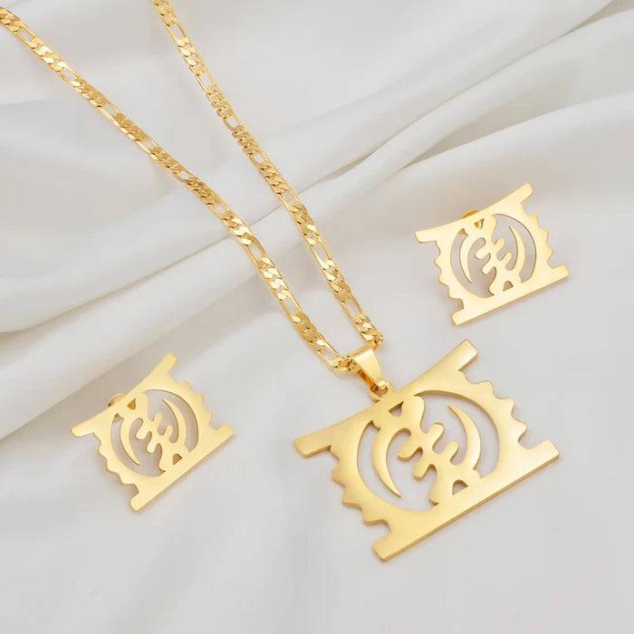 Gold-tone jewelry set featuring a rectangular pendant necklace with a cutout circular symbol, a matching chain, and two matching square earrings, arranged on a white draped fabric background.