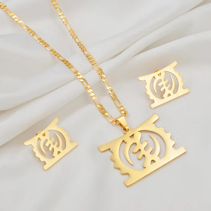 Gold-tone jewelry set featuring a rectangular pendant necklace with a cutout circular symbol, a matching chain, and two matching square earrings, arranged on a white draped fabric background.