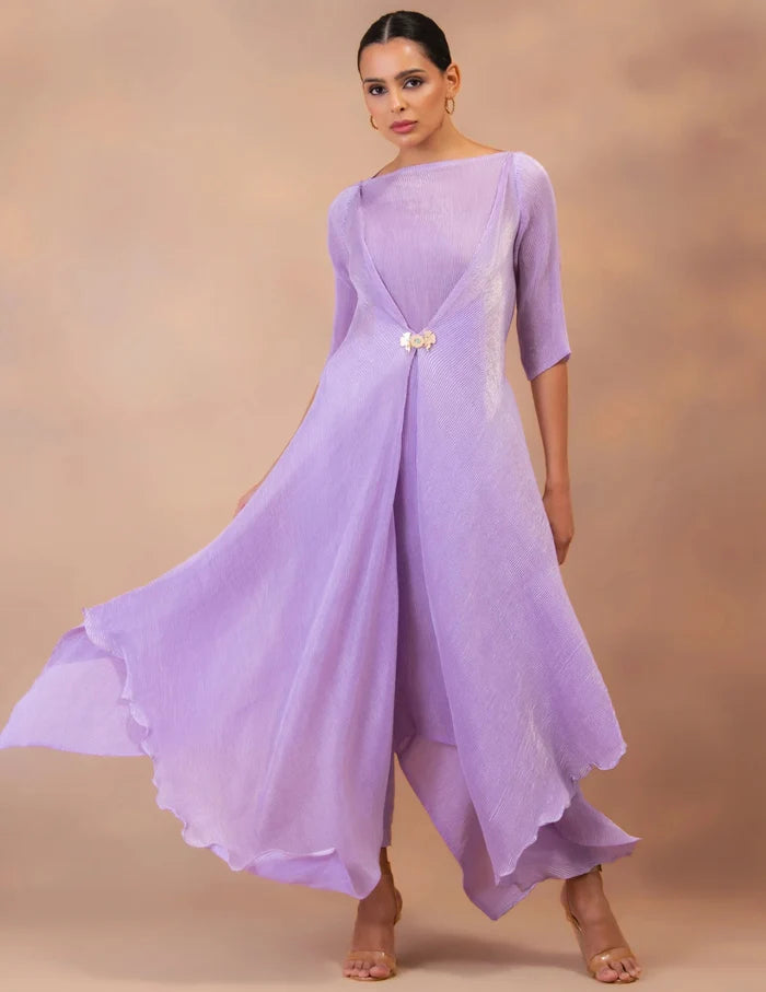 Model wearing the 'AMETHYST FLOW' layered tunic drape-dress set with matching pants, crafted in micro-pleated georgette satin with gold foil detailing.