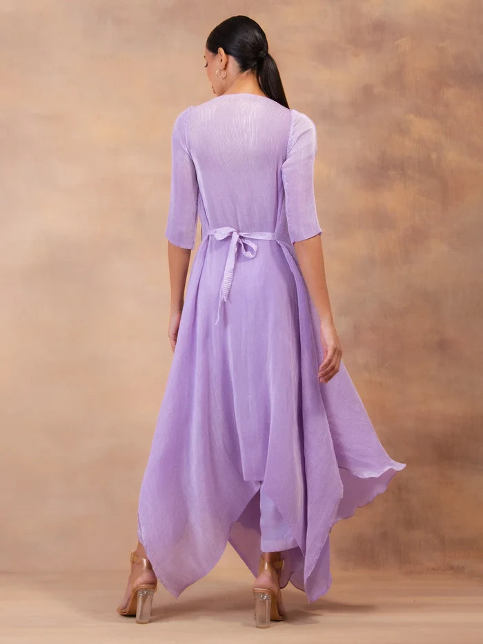 Model wearing the 'AMETHYST FLOW' layered tunic drape-dress set with matching pants, crafted in micro-pleated georgette satin with gold foil detailing.