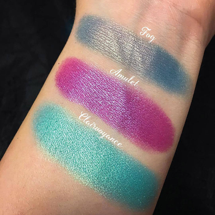 Top angled arm swatches on fair skin tone of Amulet Duochrome Eyeshadow compared to Fog, Clairvoyance