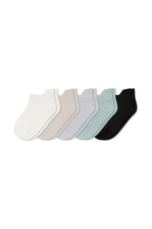 Five pairs of ankle socks in Cloud , Oat, Storm, Sage, and Midnight laying flat on a white background.