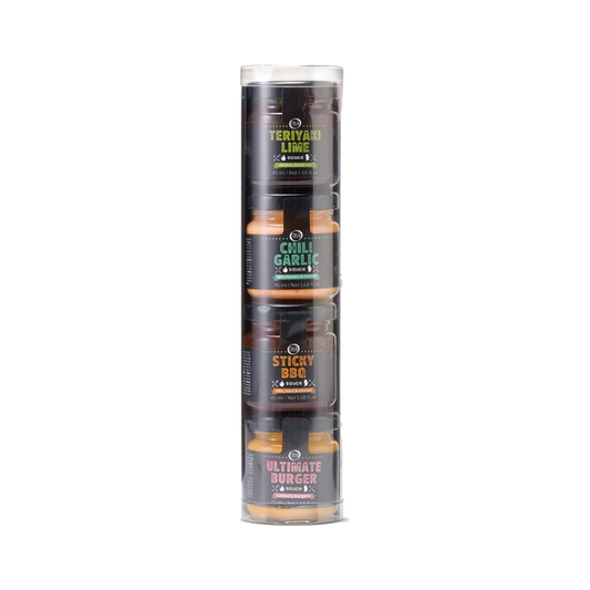 A clear plastic tube containing four small jars of different colored sauces. Each sauce bottle is labeled with a different flavor name.