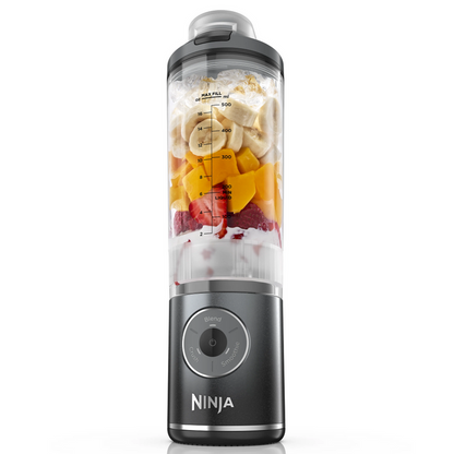 Ninja grey blender with ingredients inside on a white background