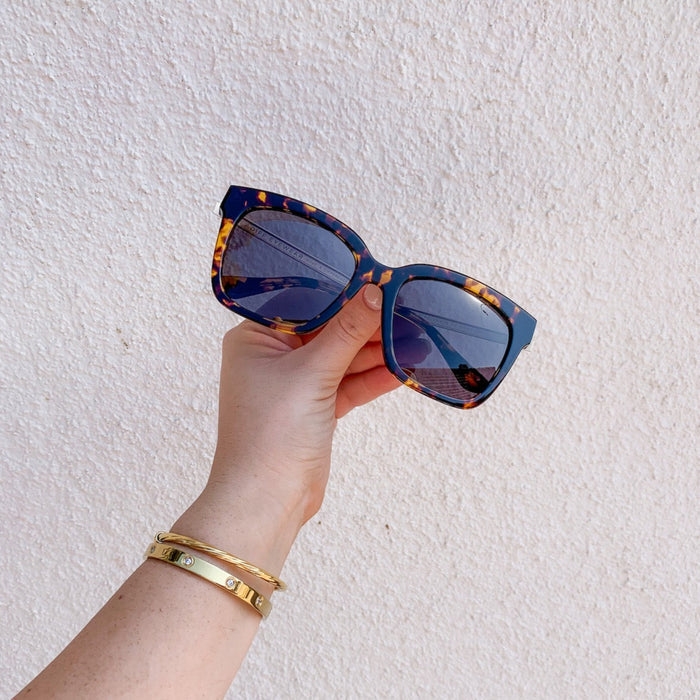 still life - diff eyewear bella square sunglasses with a tortoise frame and grey polarized lenses