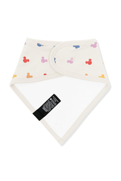 Back side fabric of bib in pastel mickey mouse icons on an oat background