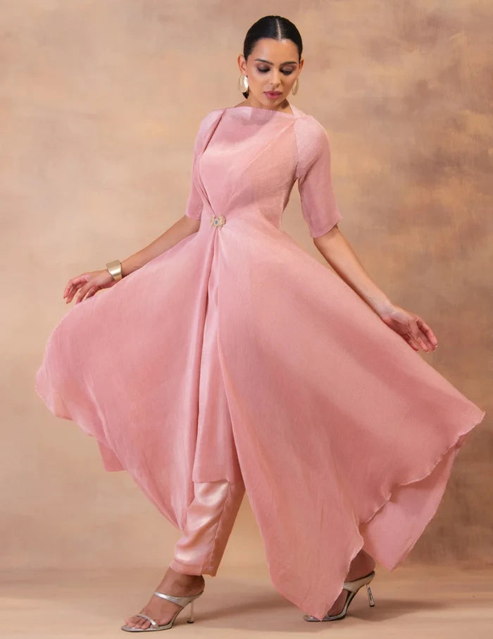 Model wearing the 'BLUSH PINK' layered tunic drape-dress set with matching pants, crafted in micro-pleated georgette satin with gold foil detailing in Singapore.