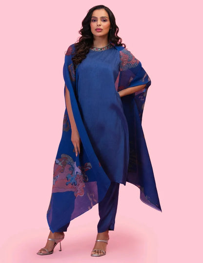 Model wearing the 'BRAHMAND BLUE' kurta set with a straight-fit Dola silk kurta, matching pants, and a statement printed georgette cape.