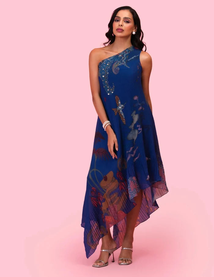 Model wearing the 'BRAHMAND BLUE' ONE SHOULDER DRESS featuring micro-pleated georgette, delicate hand embroidery, and a nature-inspired artistic print in Singapore.