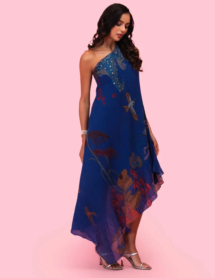 Model wearing the 'BRAHMAND BLUE' ONE SHOULDER DRESS featuring micro-pleated georgette, delicate hand embroidery, and a nature-inspired artistic print in Singapore.