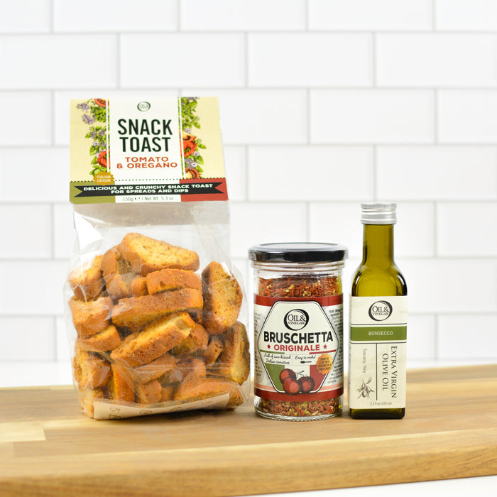Snack Toast, Bruschetta, and Olive Oil on a wooden surface with a white tiled wall background
