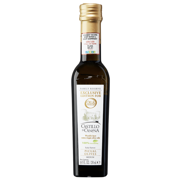 A bottle of Castillo di Canena extra virgin olive oil with a label showing the brand name and the olive variety 'Picual'.