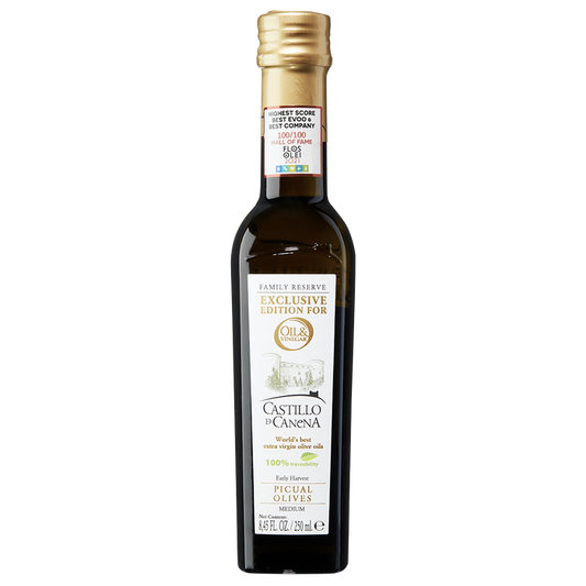 A bottle of Castillo di Canena extra virgin olive oil with a label showing the brand name and the olive variety 'Picual'.