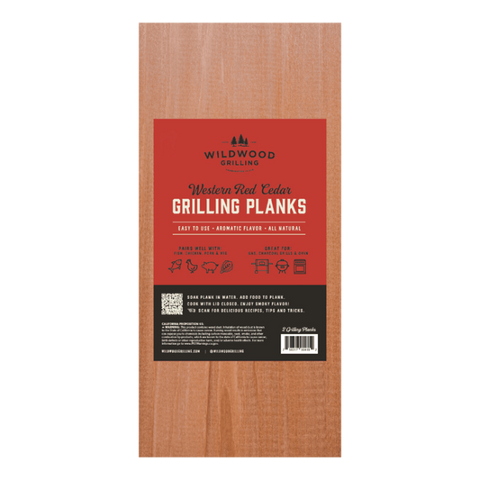 Wooden grilling plank with red label featuring Wildwood Grilling branding.