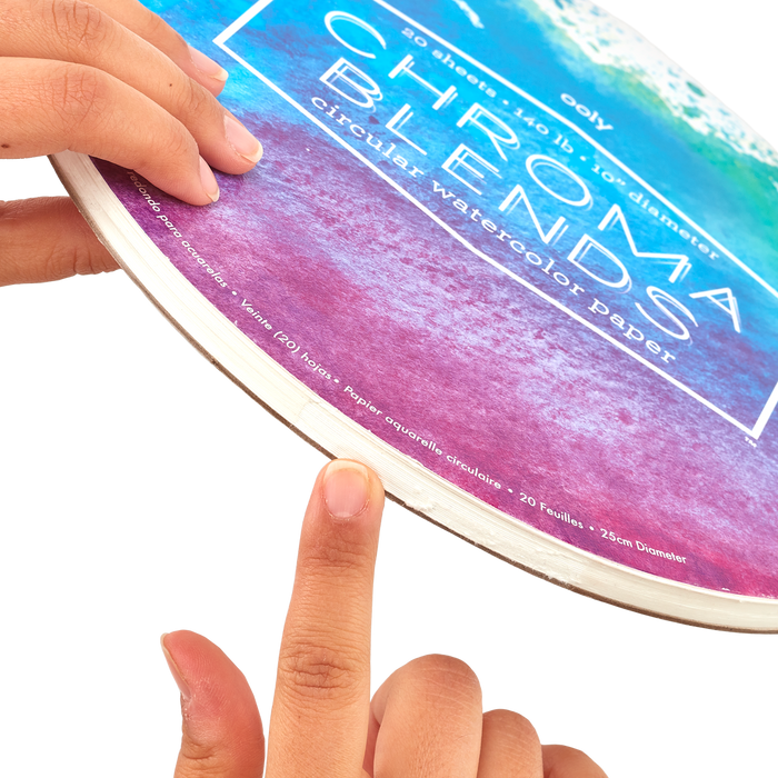 Finger pointing to the opening of the binding of the Chroma Blends Circular Watercolor Paper