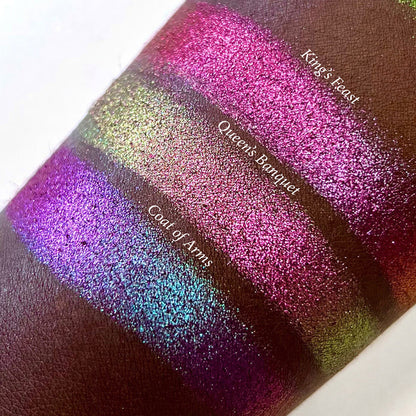 Top angled arm swatches on deep skin tone of Coat of Arms Hybrid Multichrome shifts compared to King's Feast and Queen's Banquet