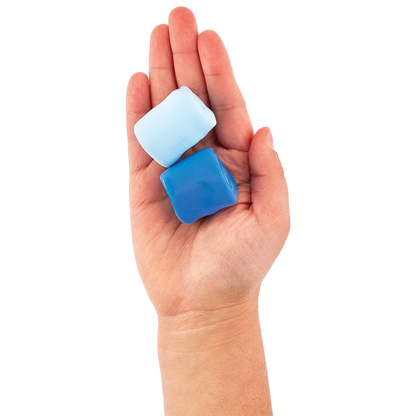 Two blue clay blocks from an OOLY Creatibles Standard Air Dry Clay Kit held in a hand against a white background