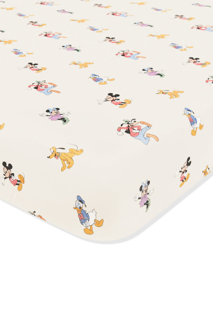 Crib sheet with mickey mouse and friends print on an oat background