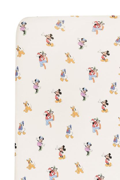 Crib sheet fabric in mickey mouse and friends print on an oat background