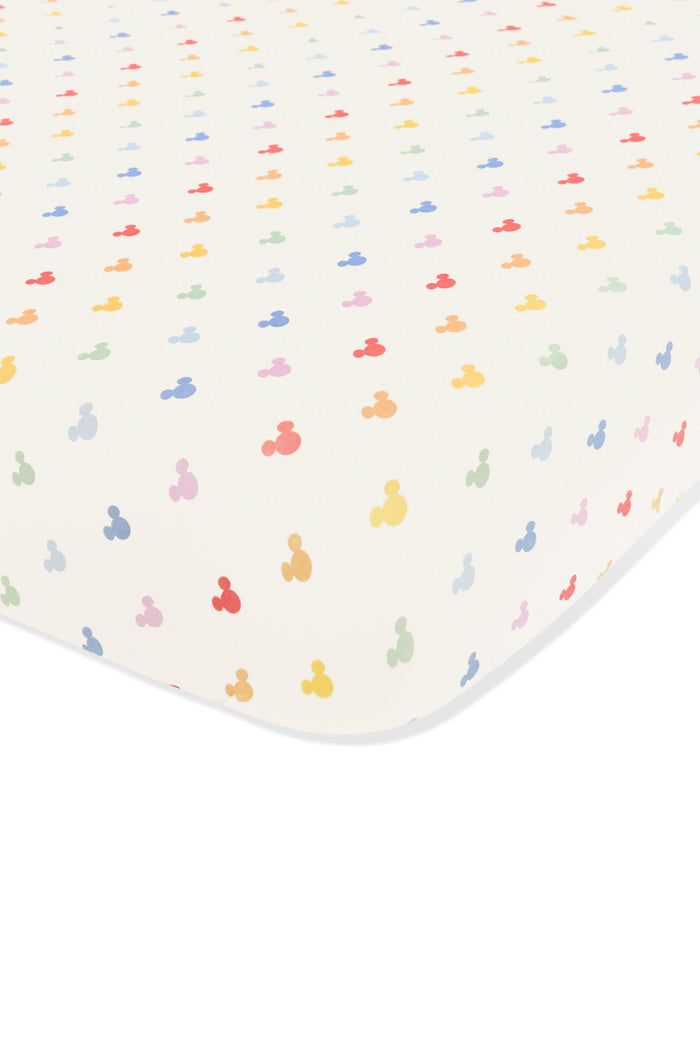 Crib sheet with pastel mickey mouse pattern on an oat background