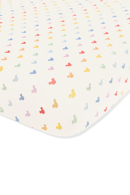 Crib sheet with pastel mickey mouse pattern on an oat background