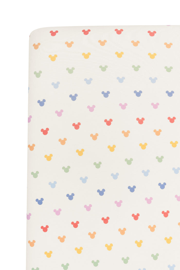 Fabric with pastel mickey mouse icons on an oat background