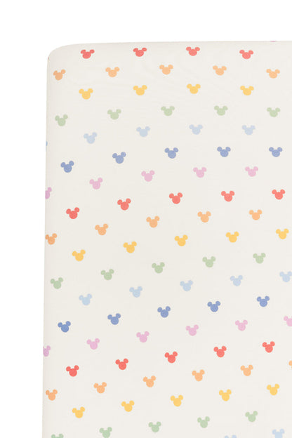 Fabric with pastel mickey mouse icons on an oat background