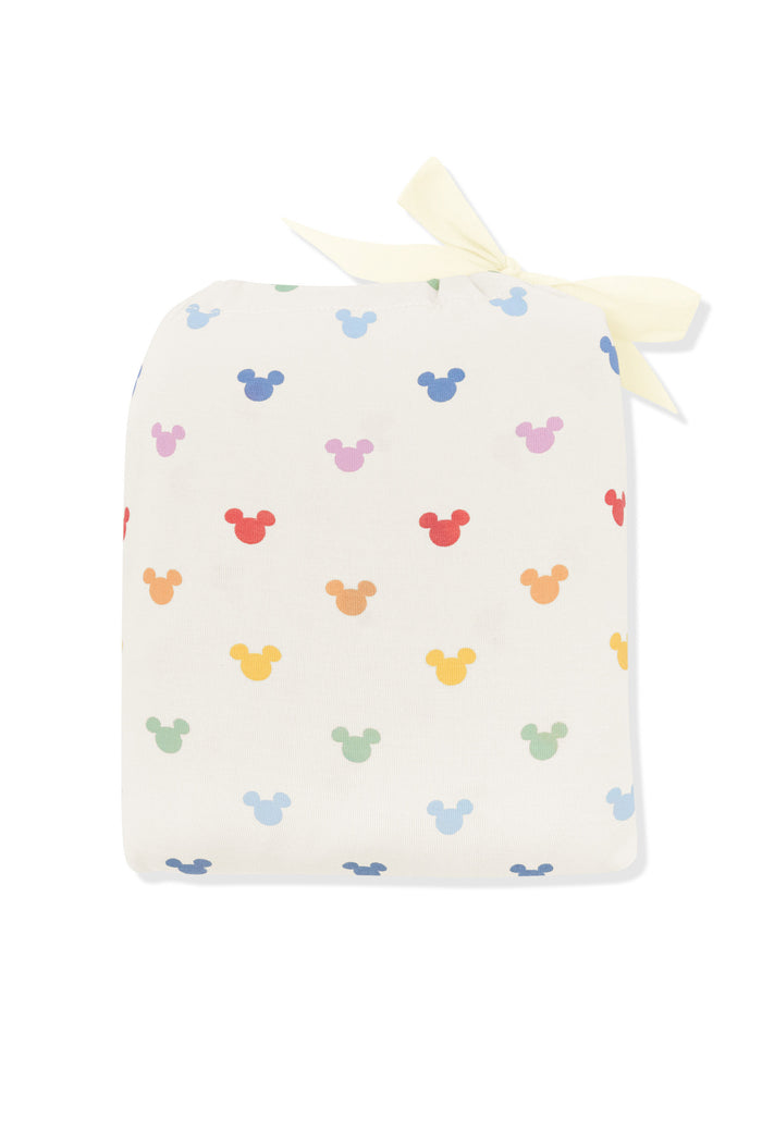 Crib Sheet in pastel mickey mouse print shown in its packaging