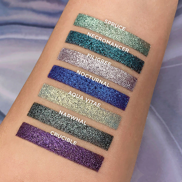 Top angled arm swatches on fair skin tone of Penumbra Bundle including Spruce, Necromancer, Filigree, Nocturnal, Aqua Vitae, Narwhal, Crucible