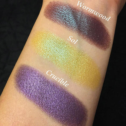 Top angled arm swatches on fair skin tone of Crucible Duochrome Eyeshadow compared to Wormwood, Sol