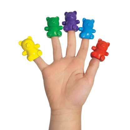Child's hand with Cuddly Cubs bear finger crayons on fingers