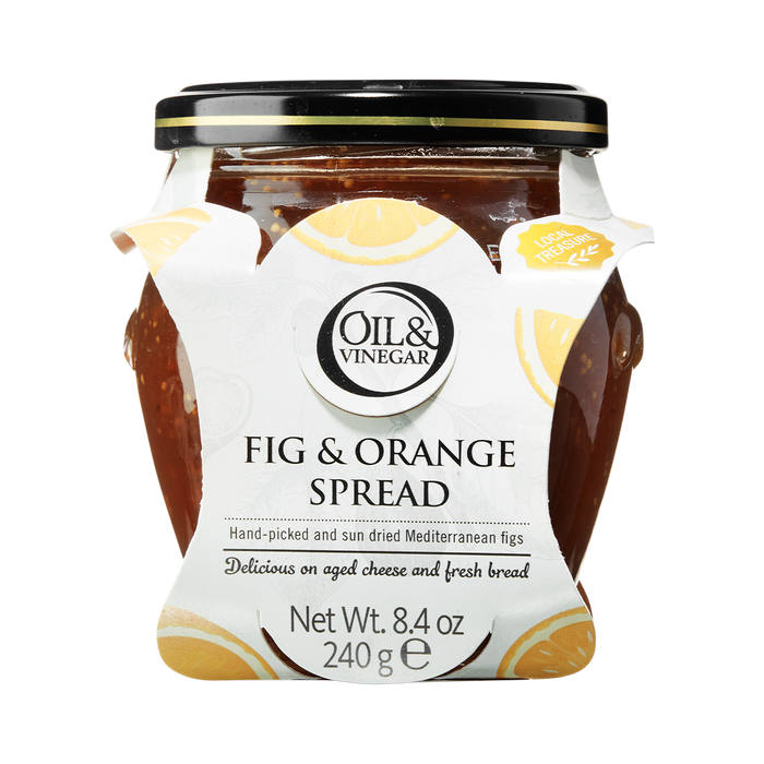 A glass jar of Dried Fig & Orange Spread with a white label that includes the brand 'Oil & Vinegar' and product name. The jar is filled with figs and visible pieces of orange, indicating the flavor of the spread.