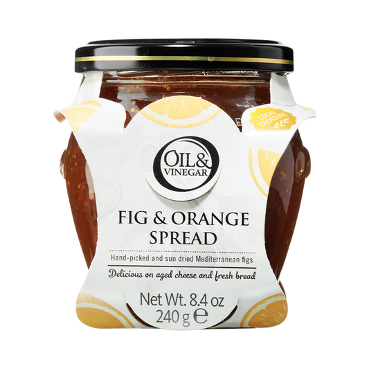 A glass jar of Dried Fig & Orange Spread with a white label that includes the brand 'Oil & Vinegar' and product name. The jar is filled with figs and visible pieces of orange, indicating the flavor of the spread.