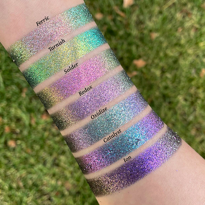 Arm swatches taken outside of Ferric, Tarnish, Solder, Redox, Oxidize, Catalyst and Ion on fair skin tone.