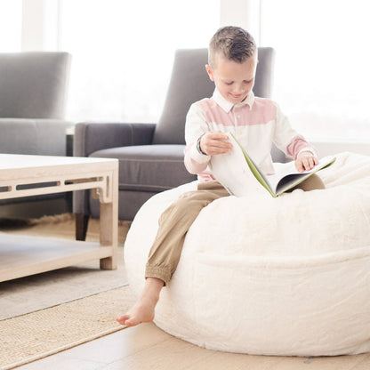 Child sitting on a Saranoni Bean Bag, enjoying a cozy read in a bedroom setting.
